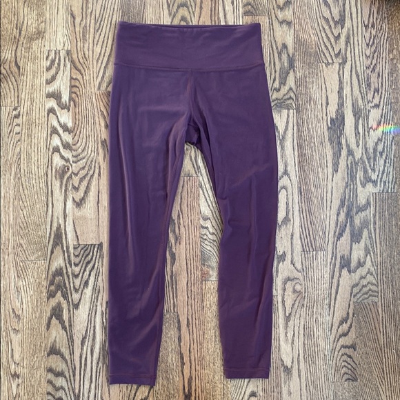 Athleta Pants - Eggplant color Athleta Elation 7/8 tights, size S. Several areas of pilling